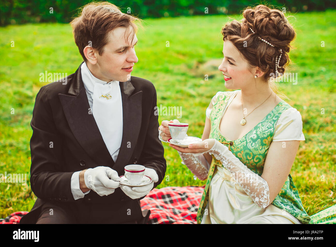 Drink Rococo Beautiful girl in the lush dress drinks tea. Photoshoot in the Rococo ...