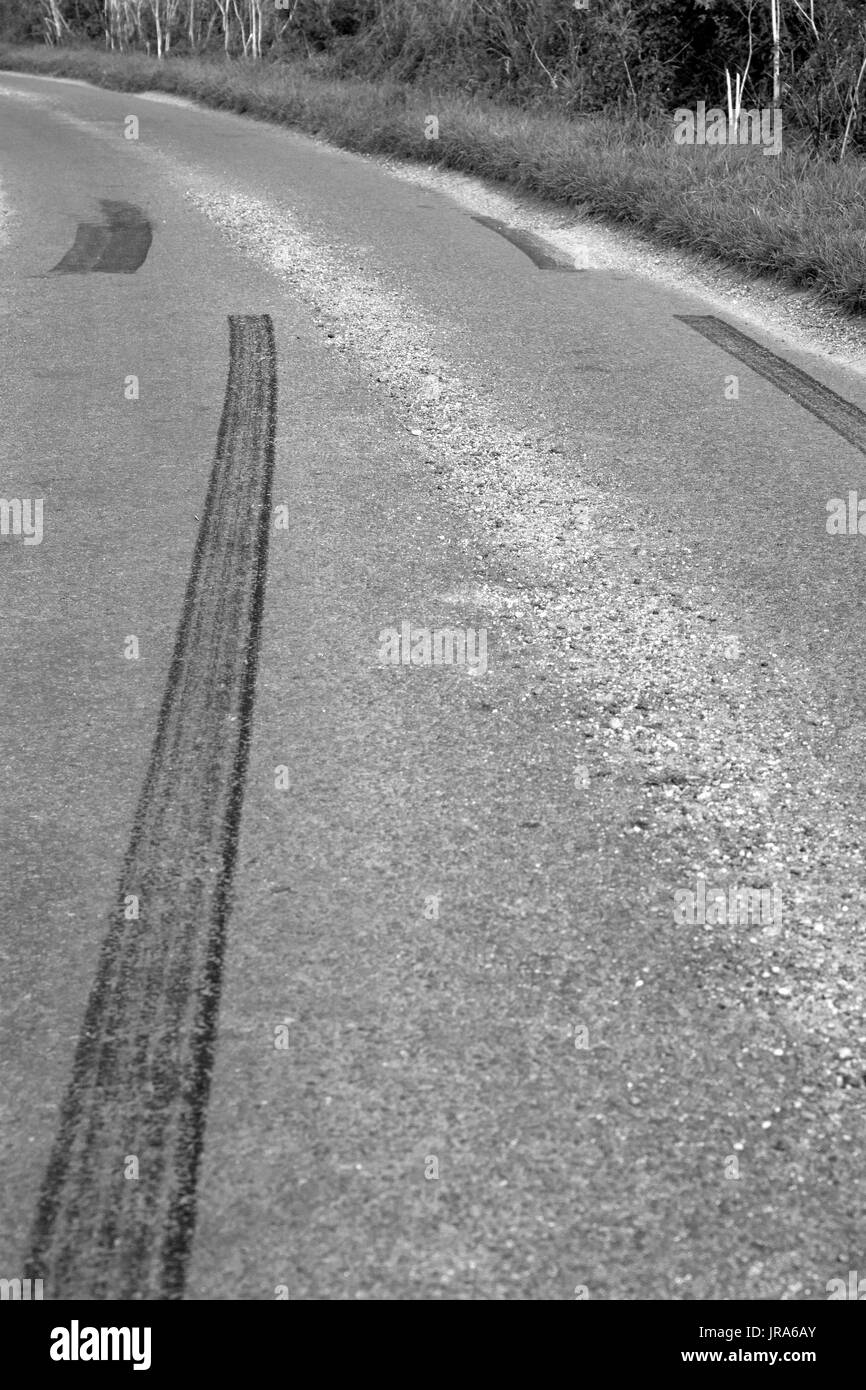 Car rubber tire skid marks left by young drivers going too fast in a