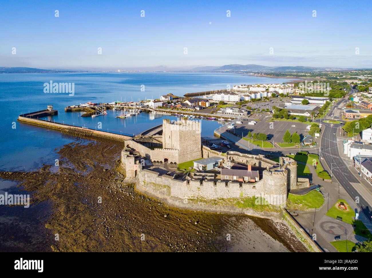 Panoramic view of Belfast Lough from Carrickfergus, Northern Ireland, showing calm waters and distant hills on a clear day.