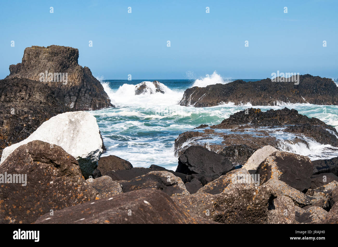 Rocks, waves and breakers at Ballintoy harbor, Northern coast of County Antrim, Norther Ireland, UK. The place featured in the Game of Thrones Stock Photo