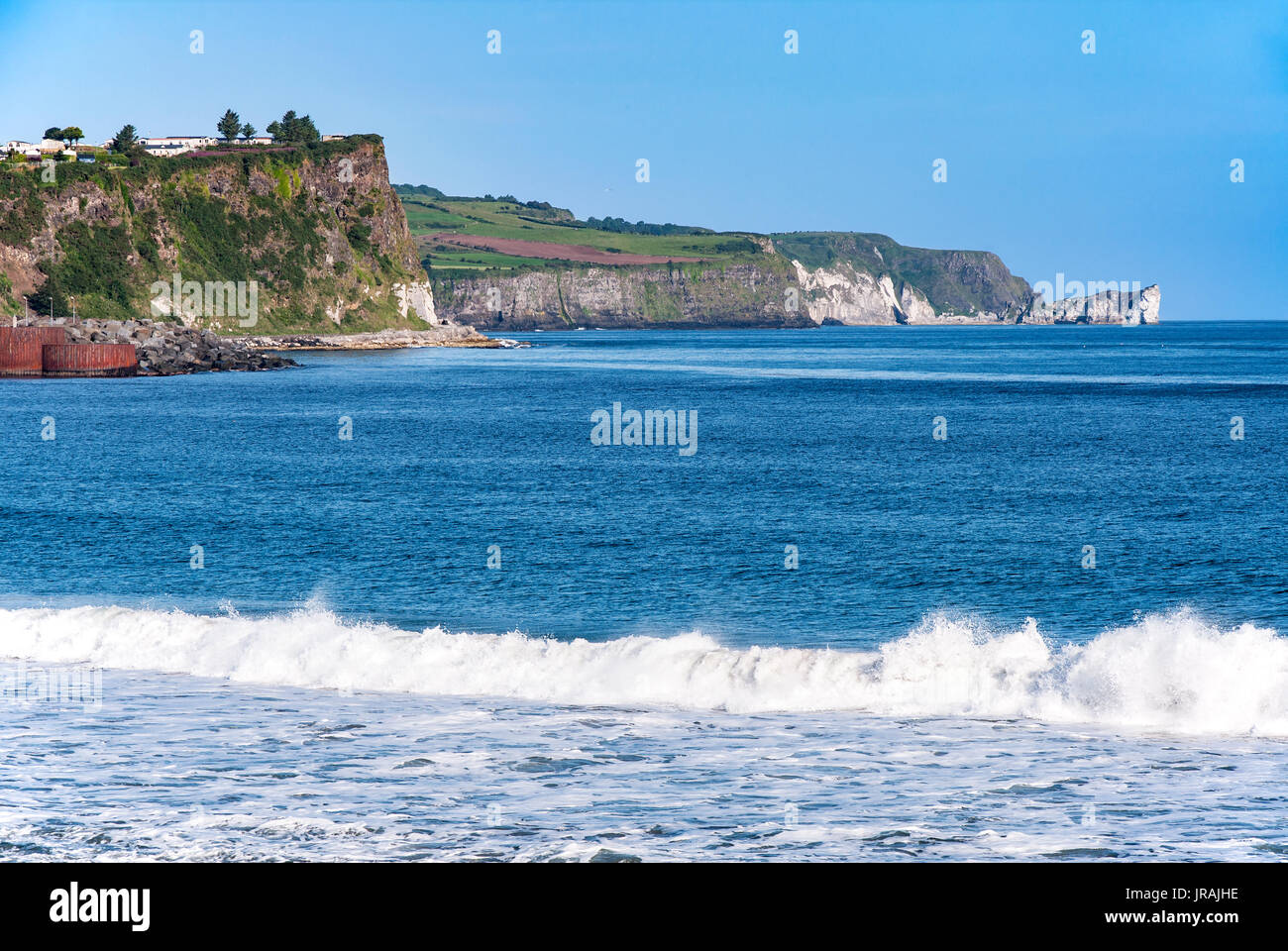 Atlantic coast with a steep cliffs and waves at Ballycastle, County Antrim, Northern Ireland, UK Stock Photo