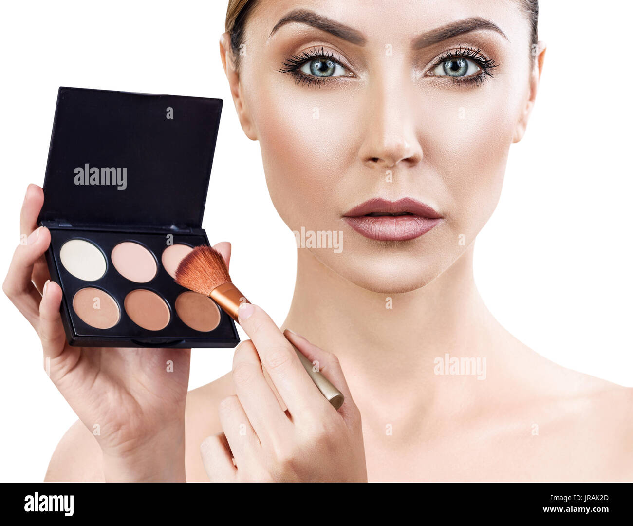 Young woman holding palette for contouring face. Stock Photo