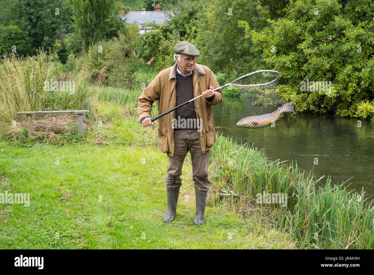 Fly fisherman fishing on the river Test, Wherwell Trout Fishery , Andover, Hampshire, England, United Kingdom. Stock Photo