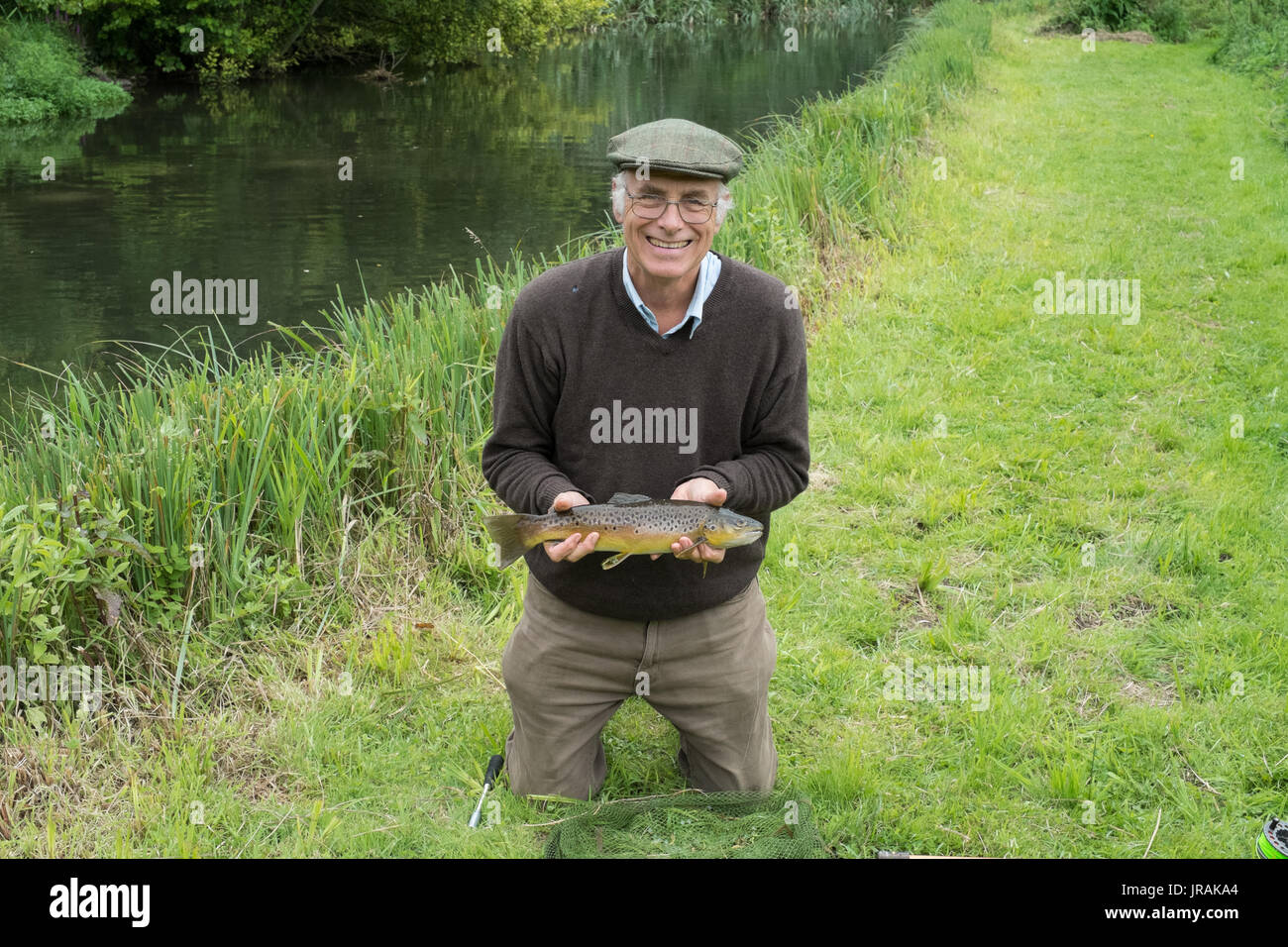 Fisherman with a Brown Trout fish, River Test , Wherwell trout fishery
