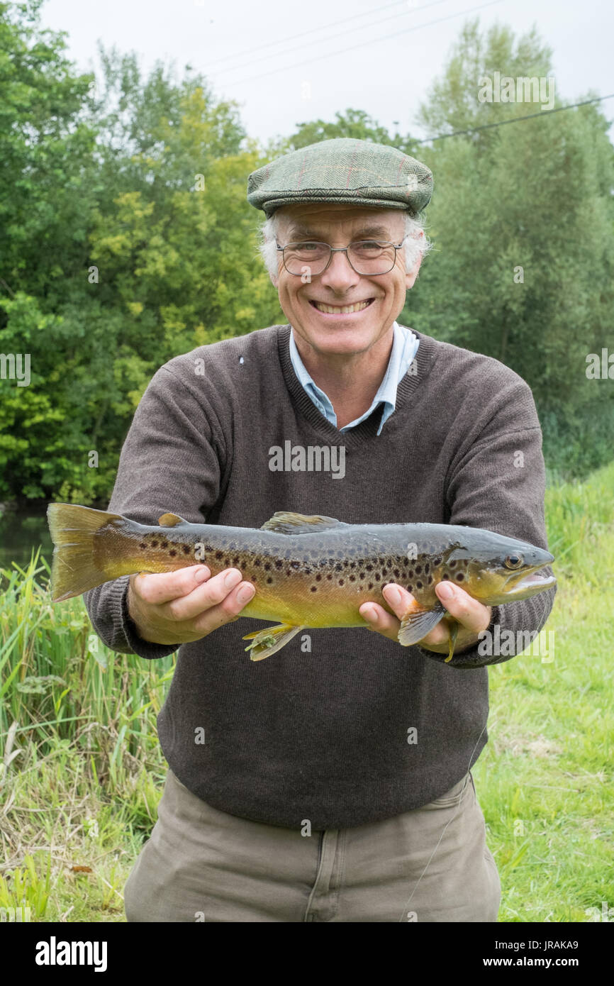 Fisherman with a Brown Trout fish, River Test , Wherwell trout fishery