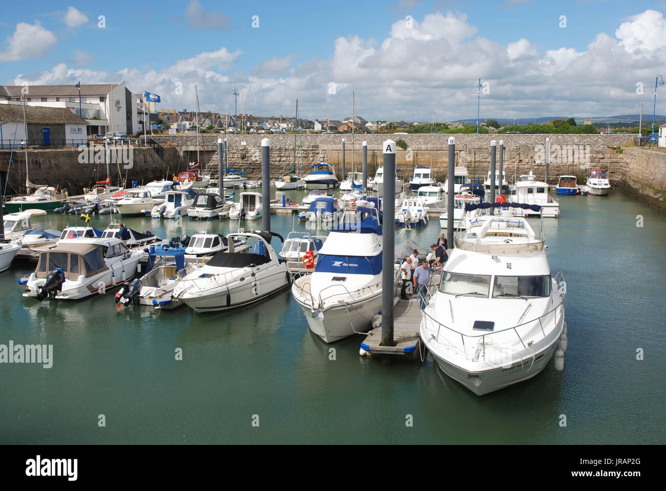 Porthcawl, Wales: Yachts and boats float in the town's harbour on a bright summer day. Stock Photo