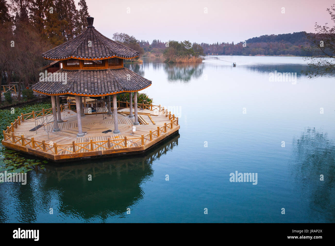 Chinese traditional wooden gazebo on the coast of West Lake, public park in Hangzhou city, China Stock Photo