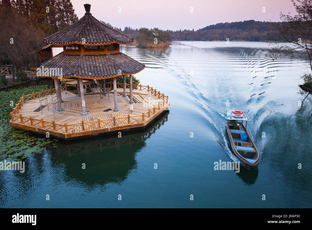 Chinese traditional wooden gazebo on the coast of West Lake, popular public park of Hangzhou city, China Stock Photo