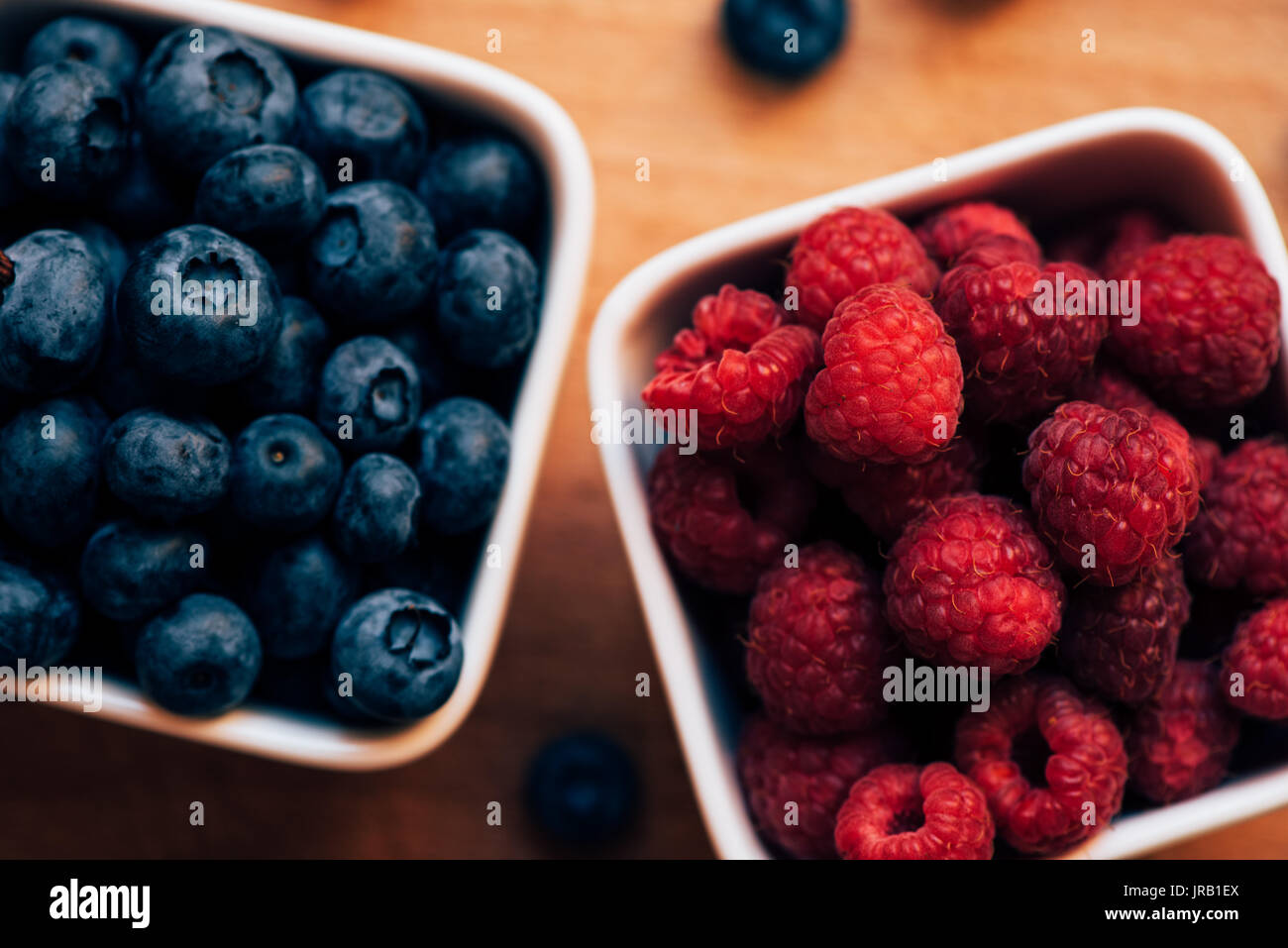 Blueberries and raspberries, healthy forest berry fruit, selective focus Stock Photo