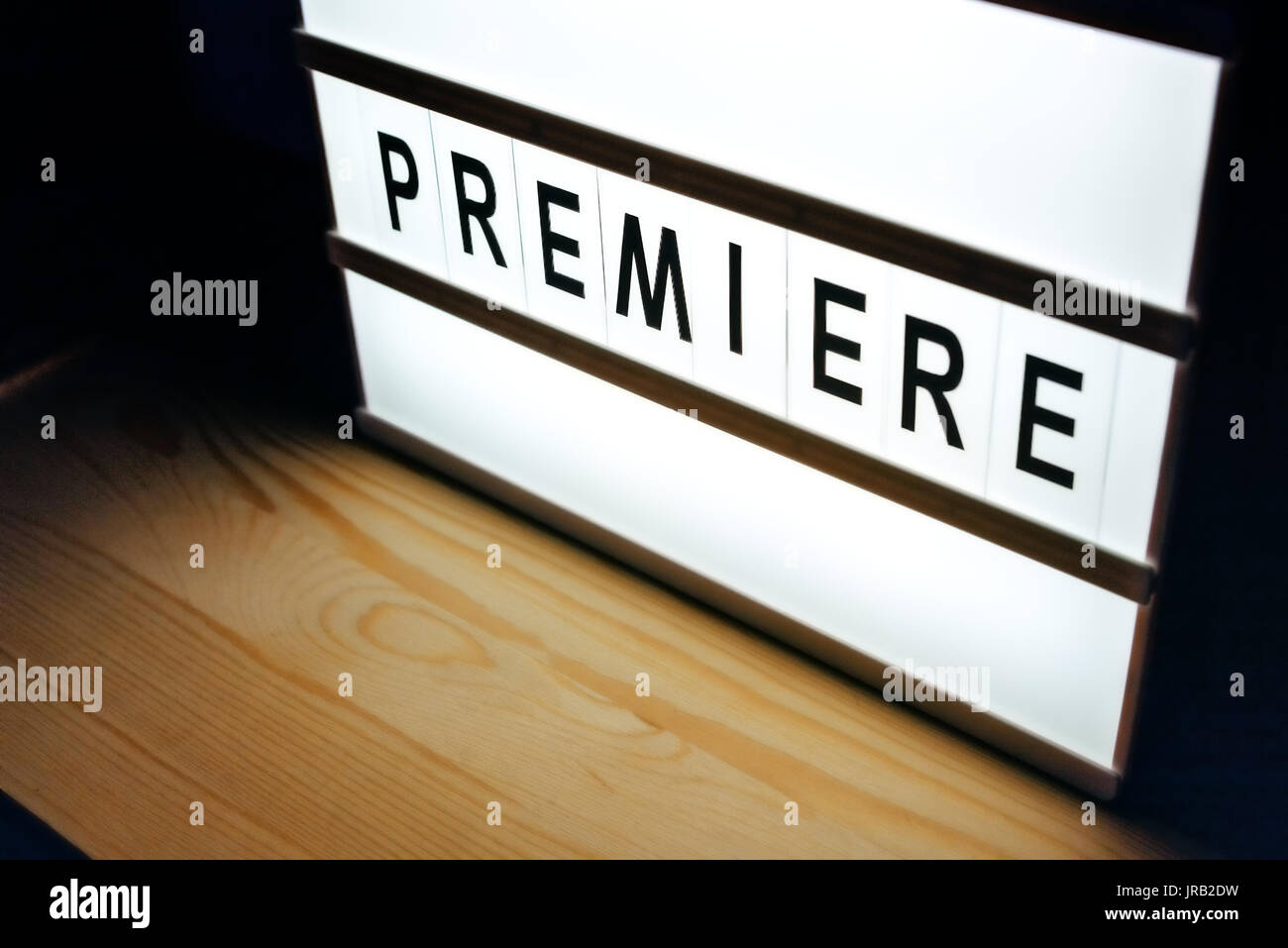 Vintage illuminated lightbox Premiere sign in cinema movie or for radio and television live audience broadcast Stock Photo