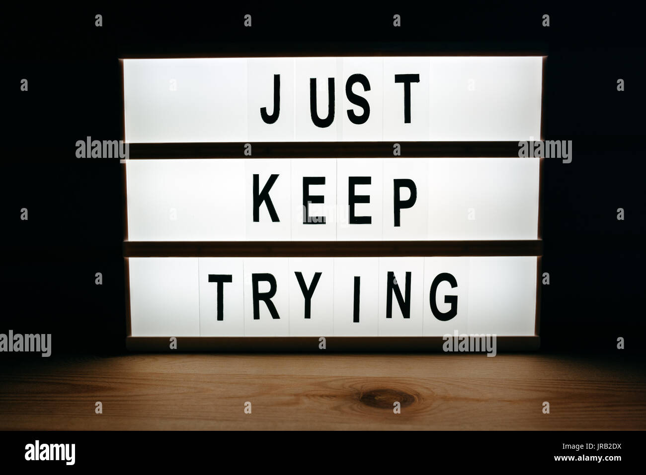 Just keep trying, motivational message on lightbox Stock Photo