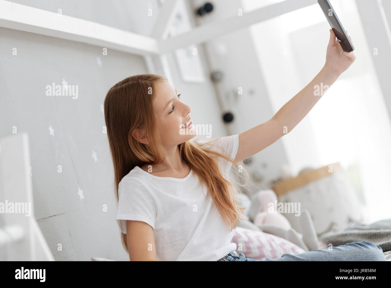 Child taking selfies at home Stock Photo