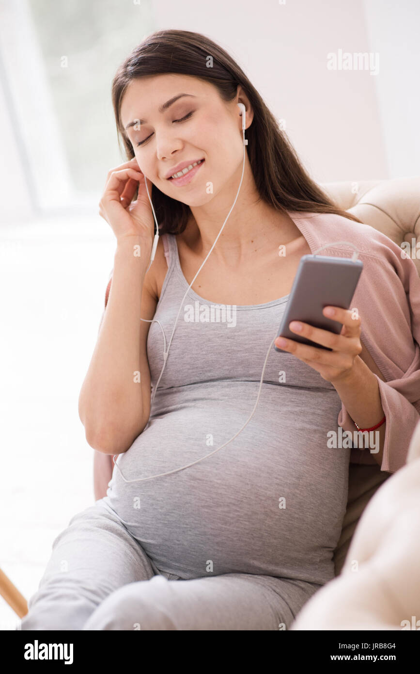Relaxed pregnant woman listening to music Stock Photo - Alamy