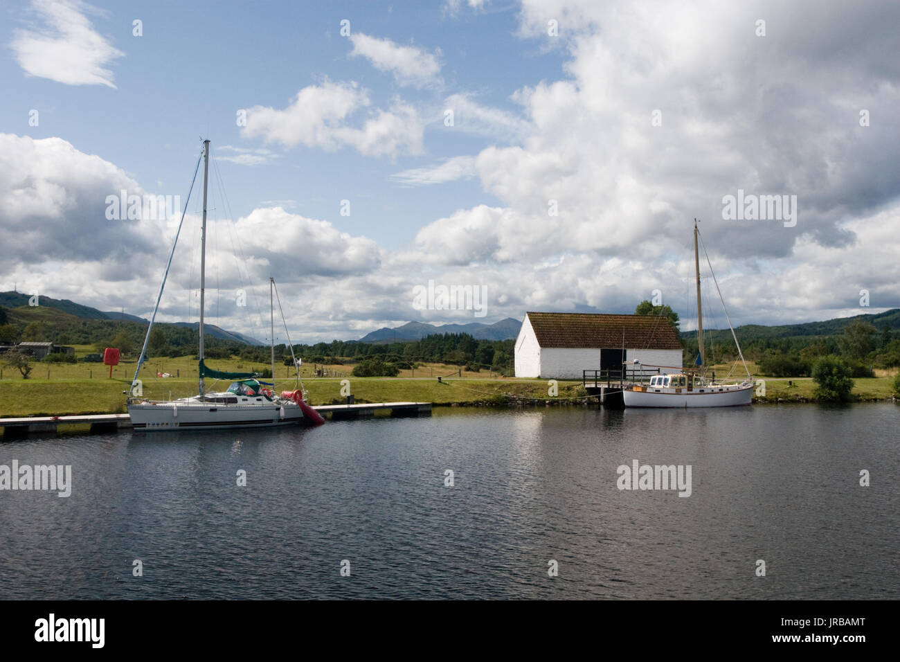 Scenic view with yachts parked in the docking pier on the Loch Ness Scottish Highlands, near Fort Augustus, Scotland Stock Photo