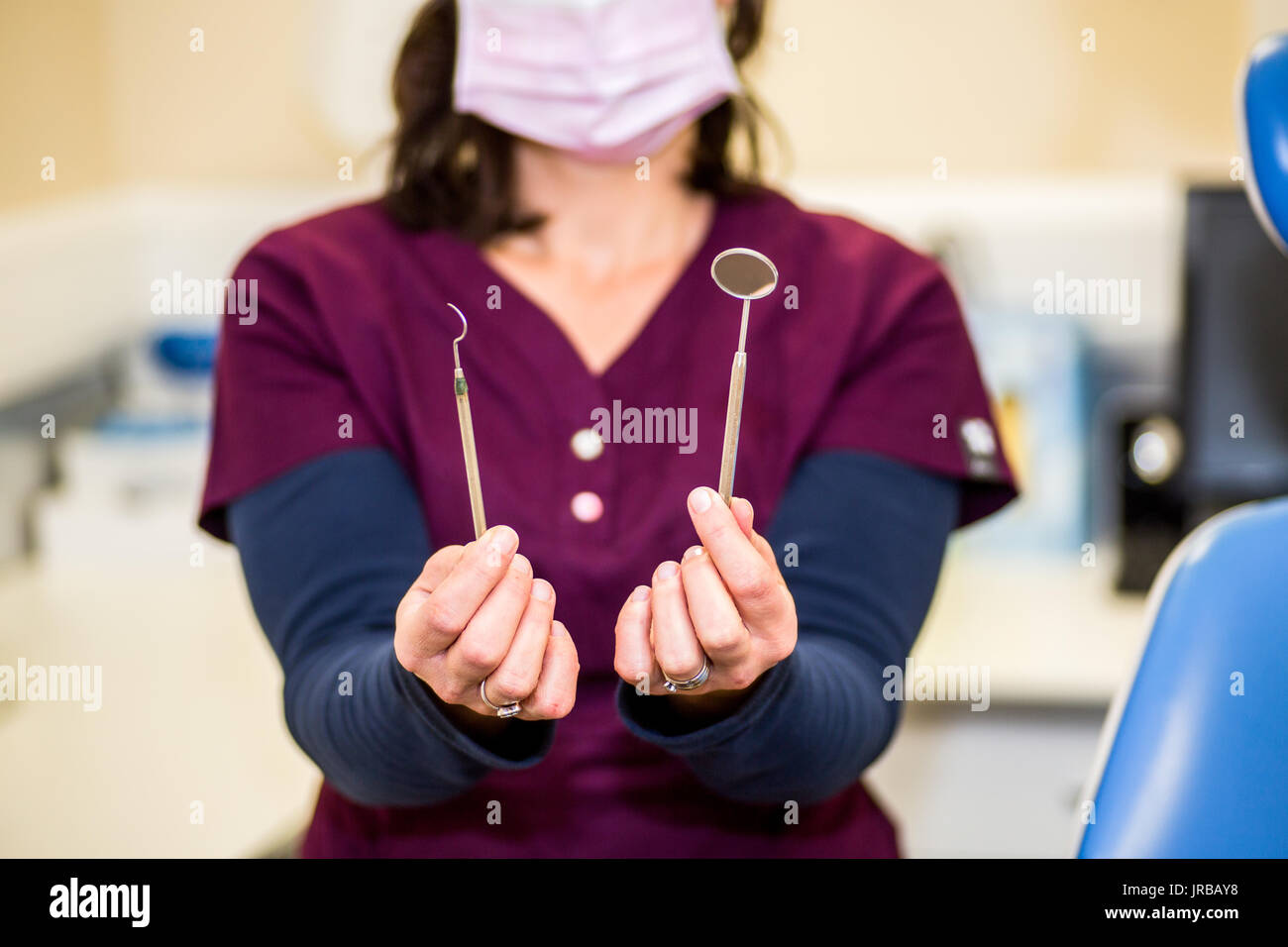 Dental nurse demonstrating dental examination instruments set a mouth