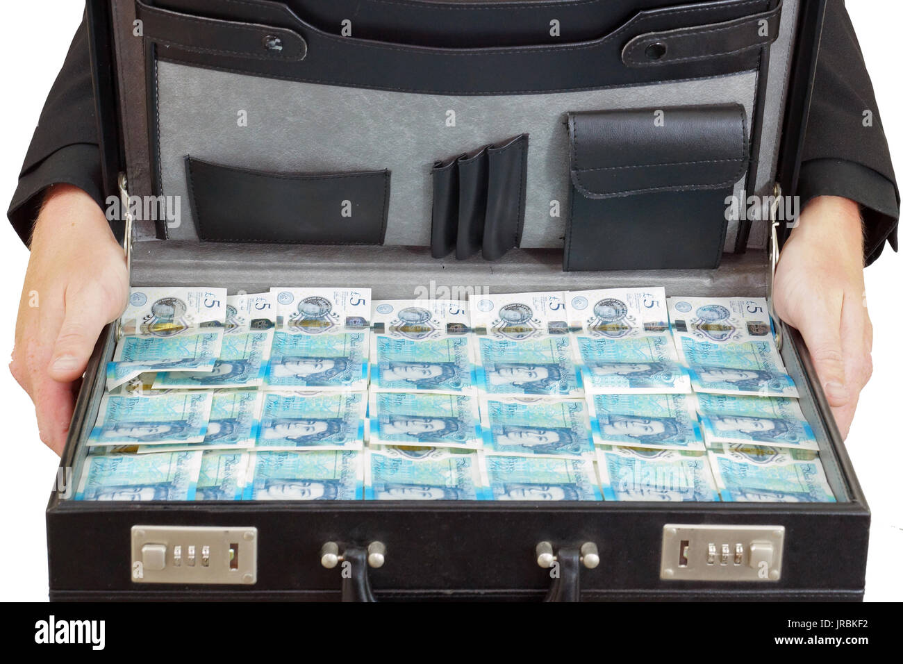 A briefcase full of the newly introduced currency of the United Kingdom - The polymer five pound (£5) note with features more measures against counter Stock Photo