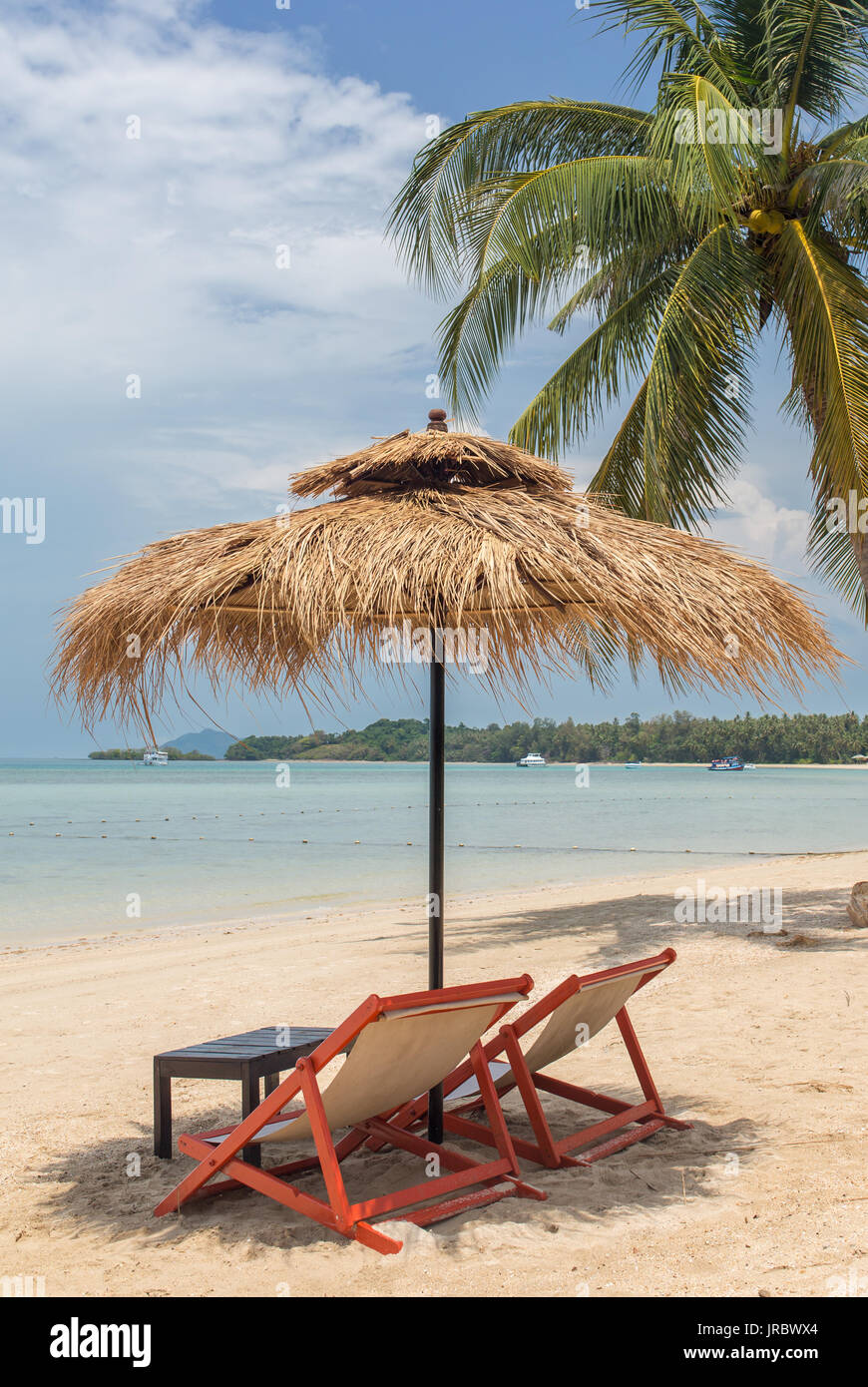 Two lounge chairs with sun umbrella on a beach Stock Photo Alamy