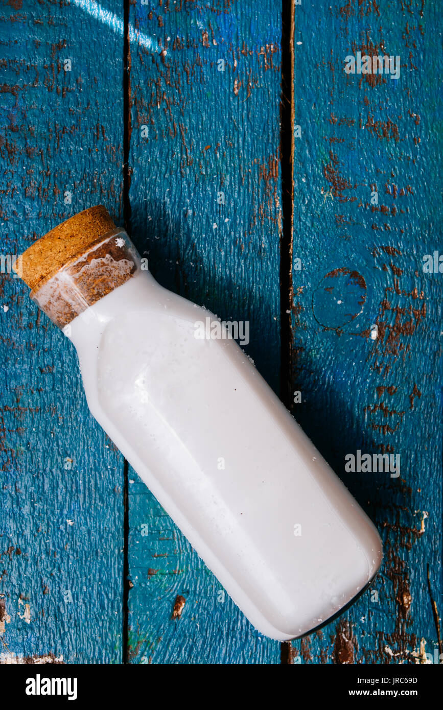 Homemade coconut milk in a bottle, mixed in a blender and pressed through a cotton sieve Stock Photo