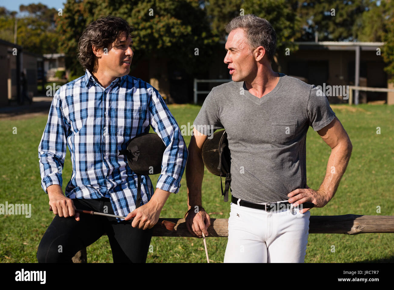 Two male friends interacting with each other in the ranch on a sunny