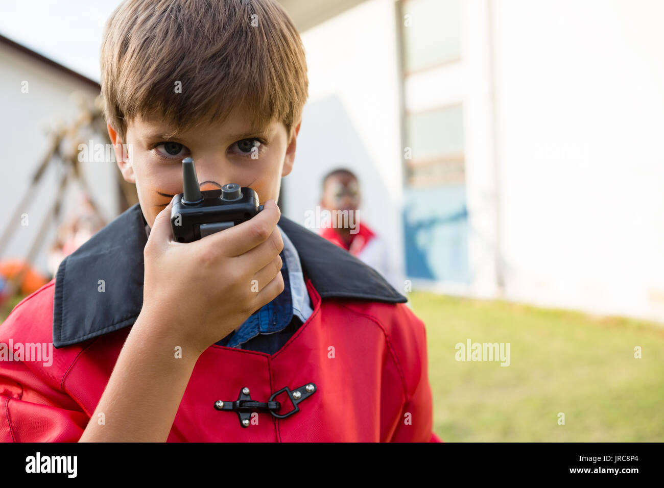 Portrait of boy with face paint using walkie talkie during birthday party Stock Photo