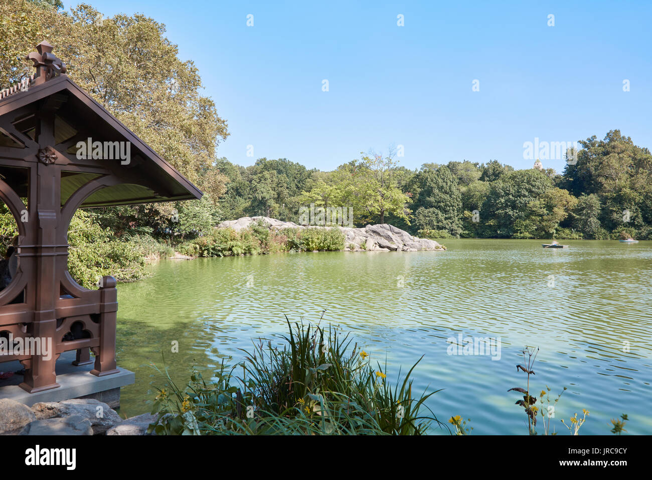 Central Park pond view and wooden canopy in a sunny day in New York Stock Photo
