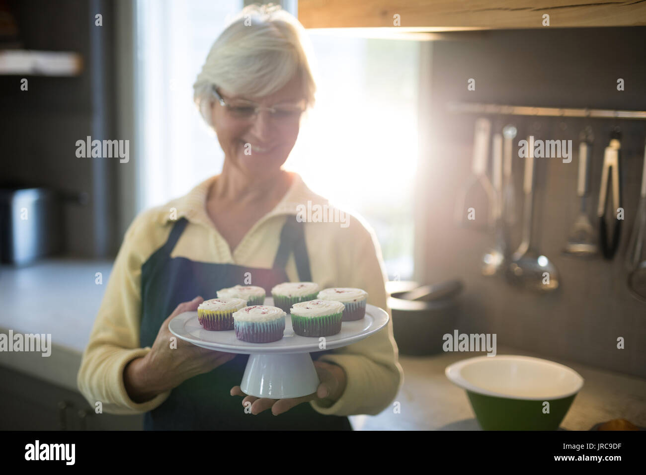 Woman baking chocolate cup cakes in glass tray in kitchen closeup. Young  girl put muffins in hot over. Female cooking tasty snack pastry at home.  Hea Stock Photo - Alamy