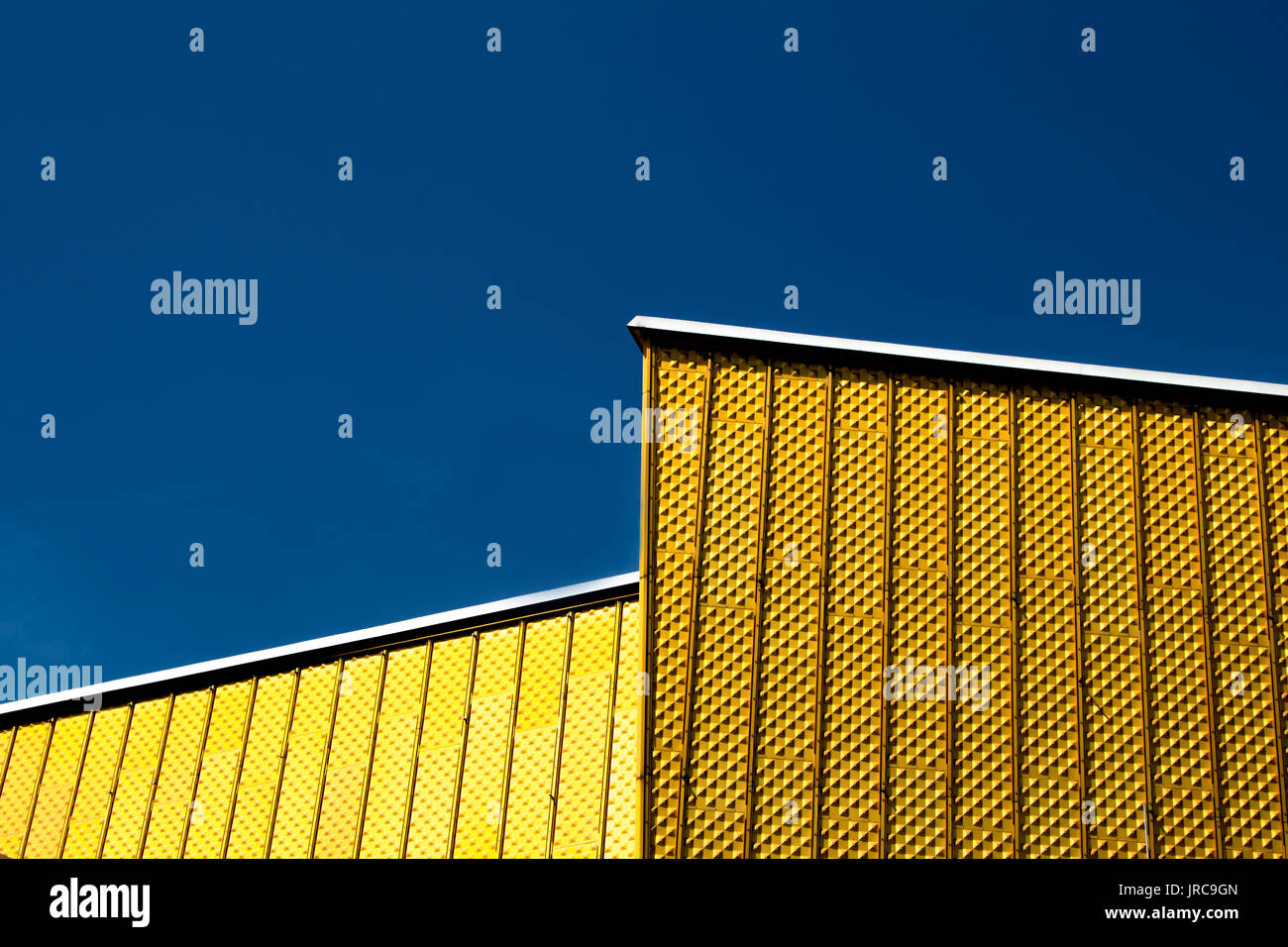 Detail of golden building with blue sky background Stock Photo