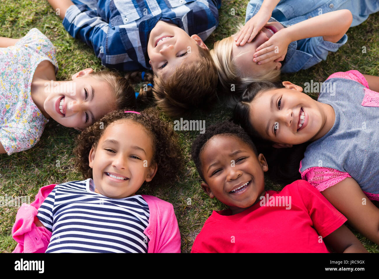 Boy lying on grass arms hi-res stock photography and images - Alamy