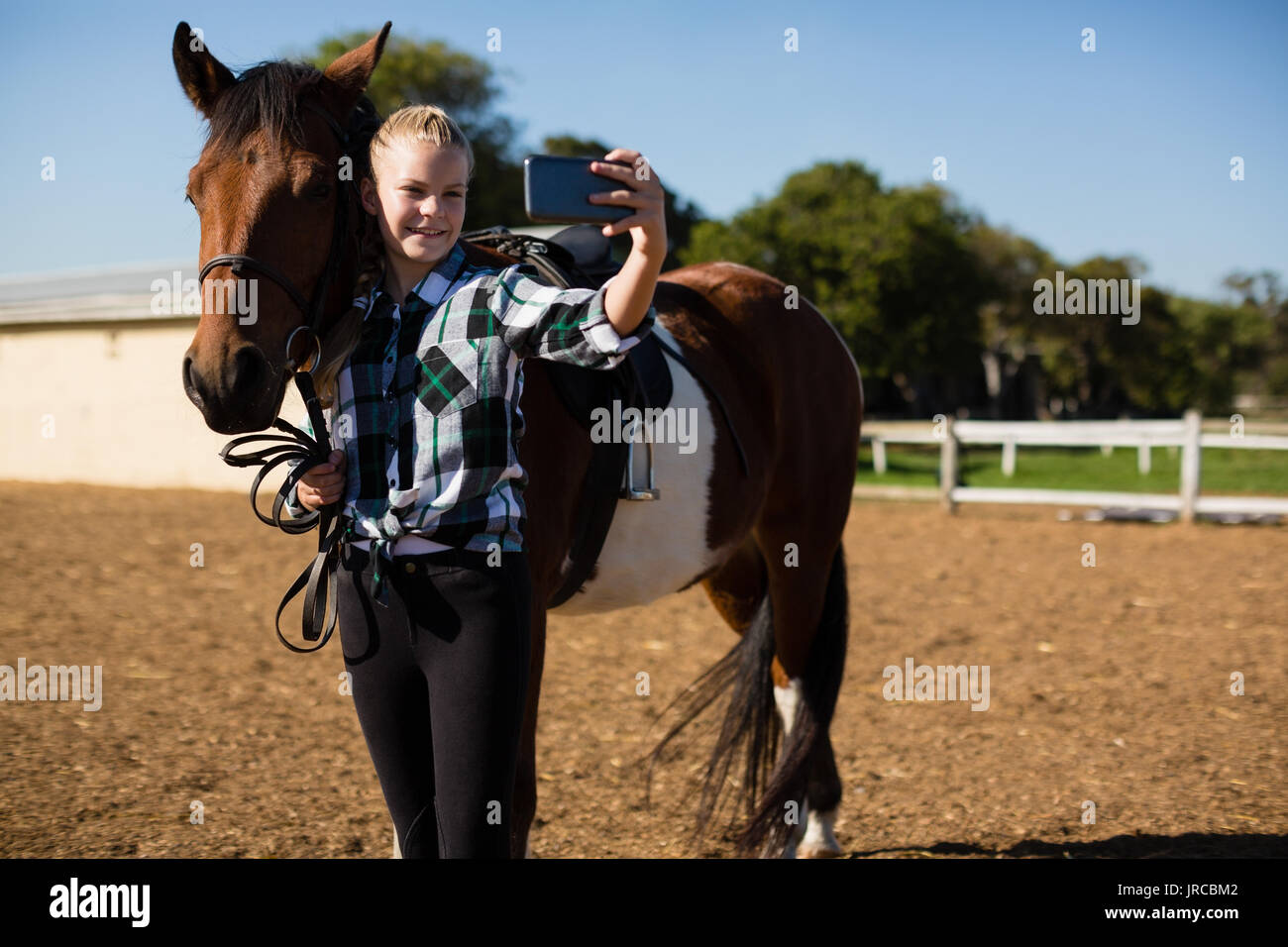 Girl taking a selfie with horse at the ranch Stock Photo - Alamy