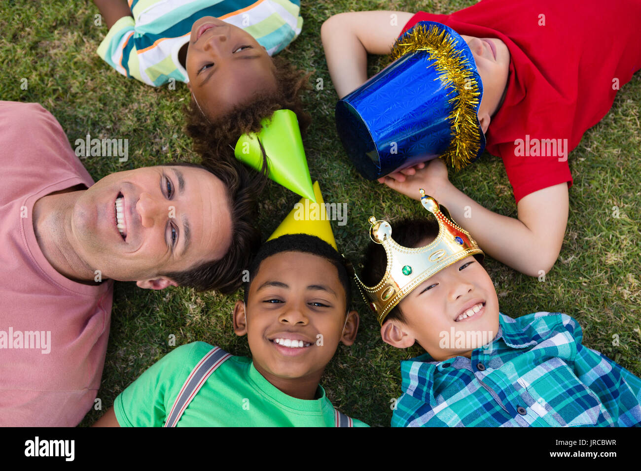 Boy lying on grass arms hi-res stock photography and images - Alamy