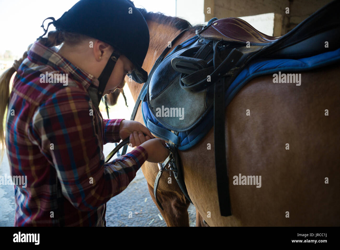 Teenage girl standing with horse in the stable Stock Photo - Alamy