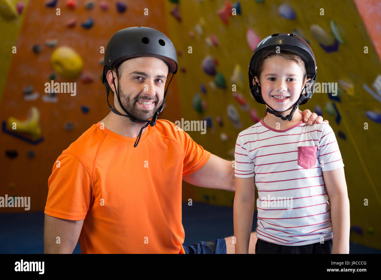 Portrait of happy trainer and kids in fitness studio Stock Photo