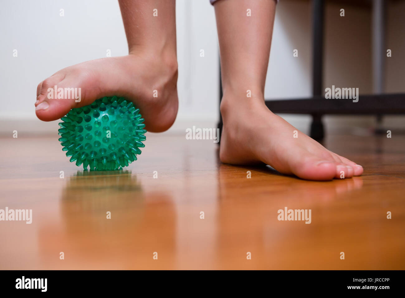 Low section of girl exercising with stress ball in hospital Stock Photo