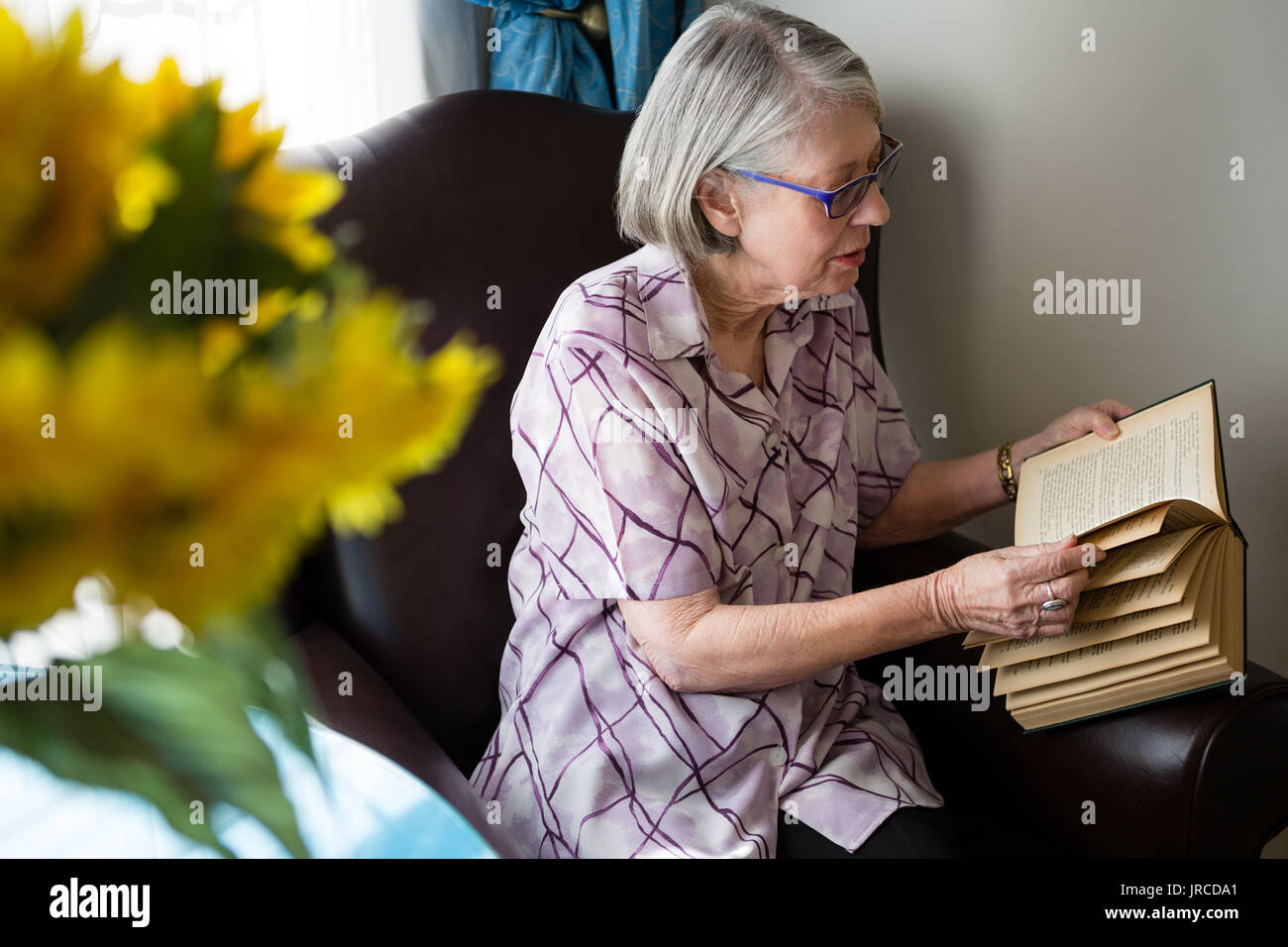 Woman sitting arm chair hi-res stock photography and images - Alamy
