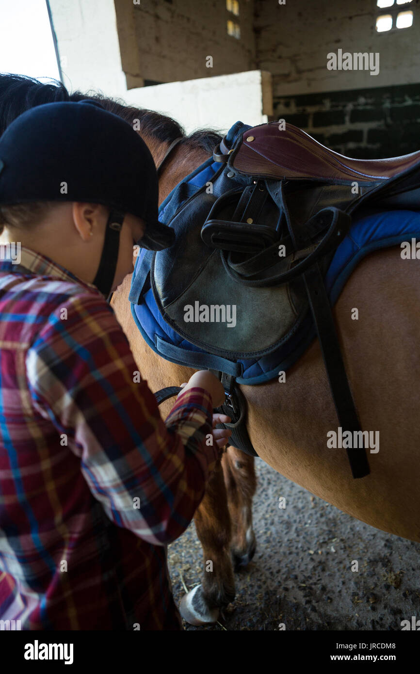 Teenage girl standing with horse in the stable Stock Photo - Alamy