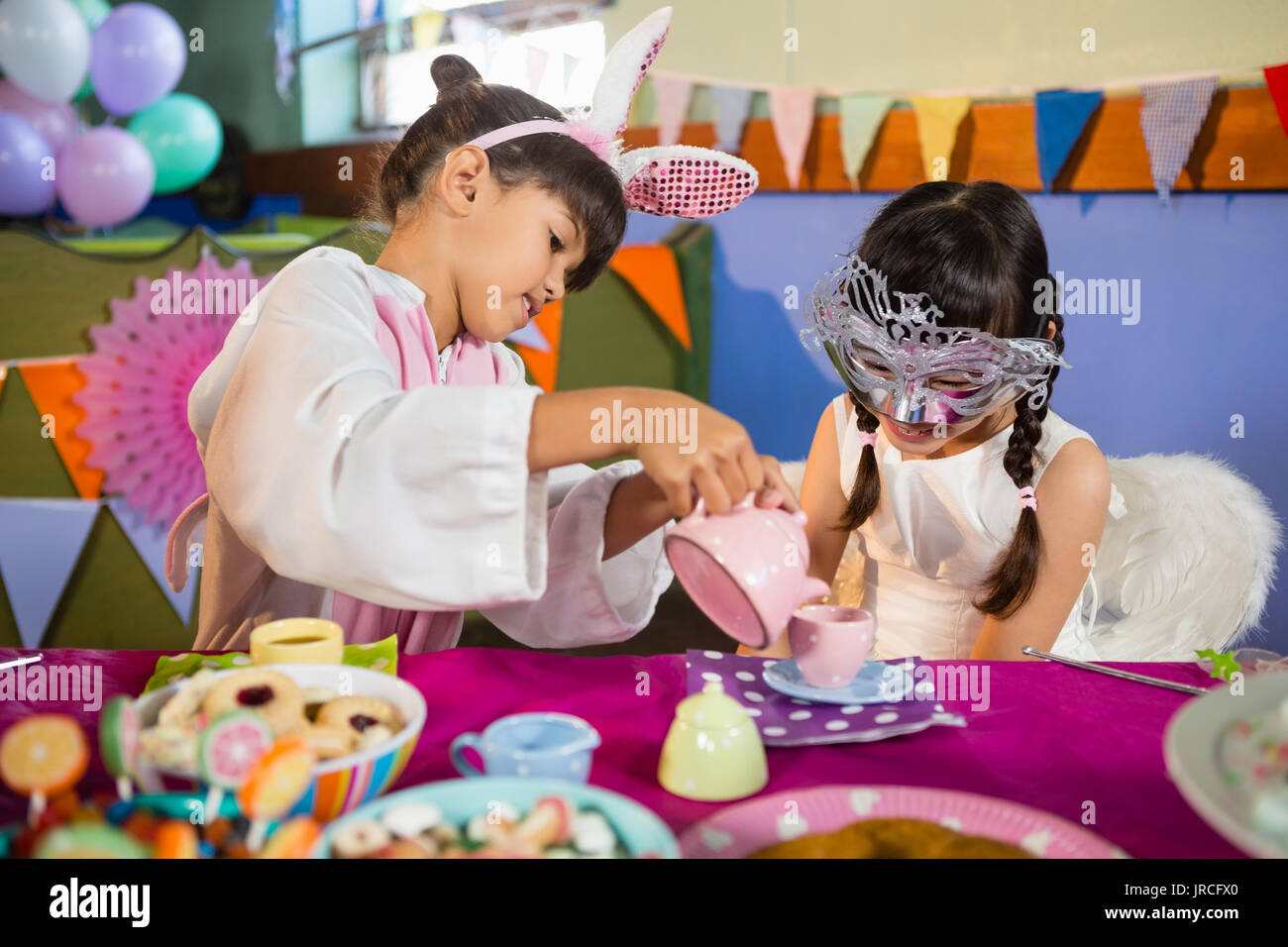 Kids playing with tea set during birthday party at home Stock Photo - Alamy