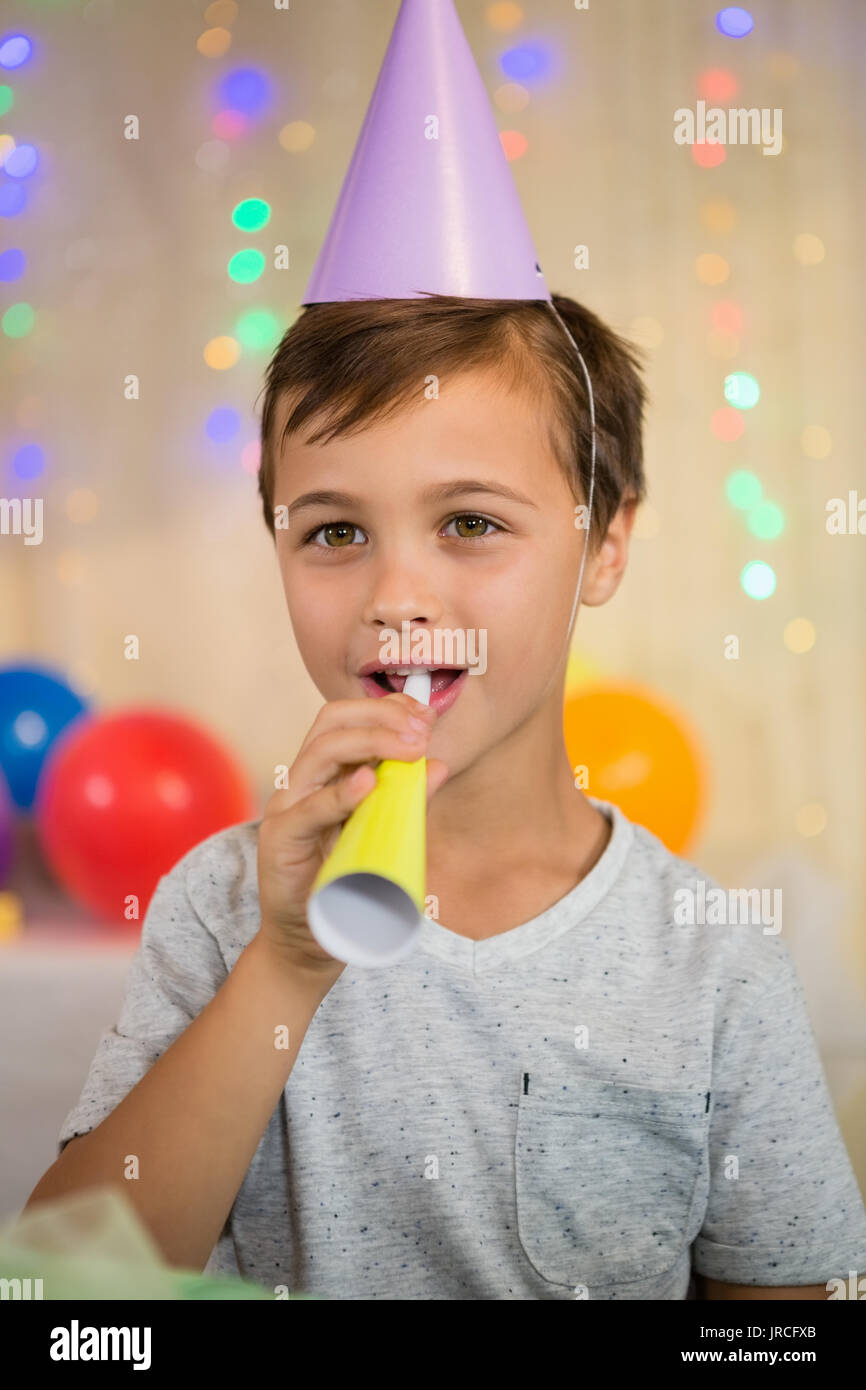 Boy blowing a party horn during birthday party at home Stock Photo Alamy