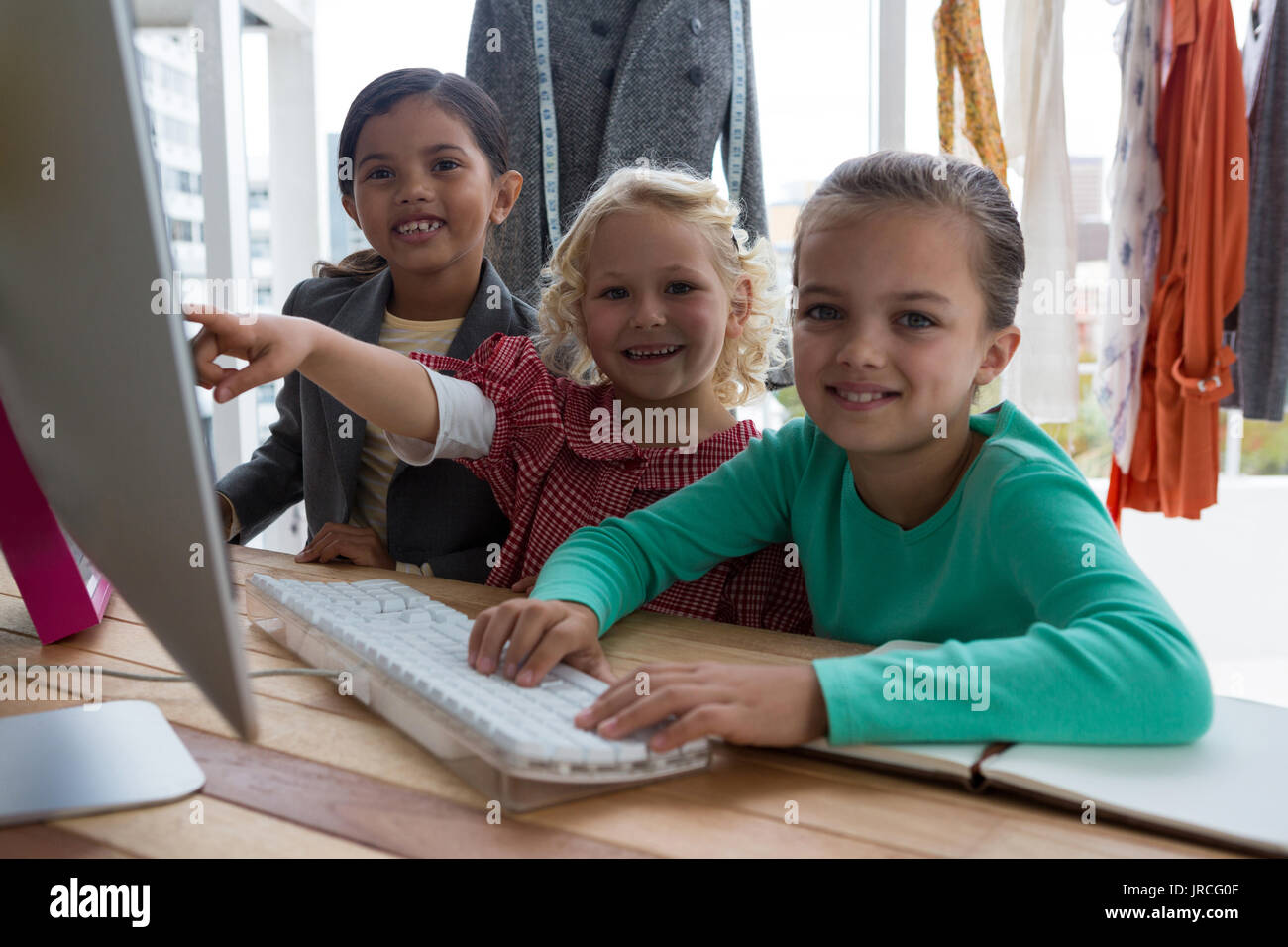 Portrait of female designers discussing over computer in creative office Stock Photo