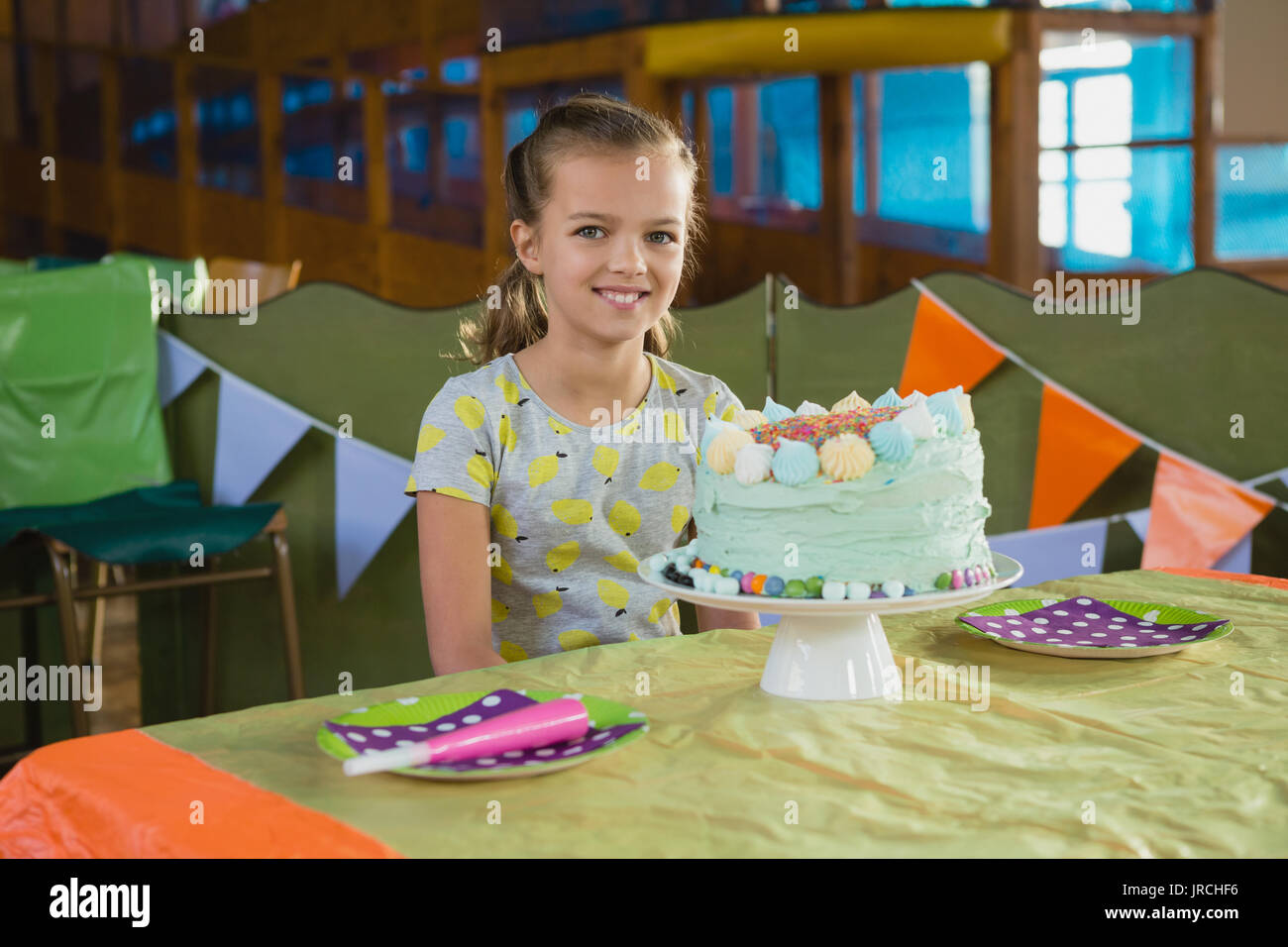 Portrait of girl sitting near a birthday cake at home Stock Photo - Alamy