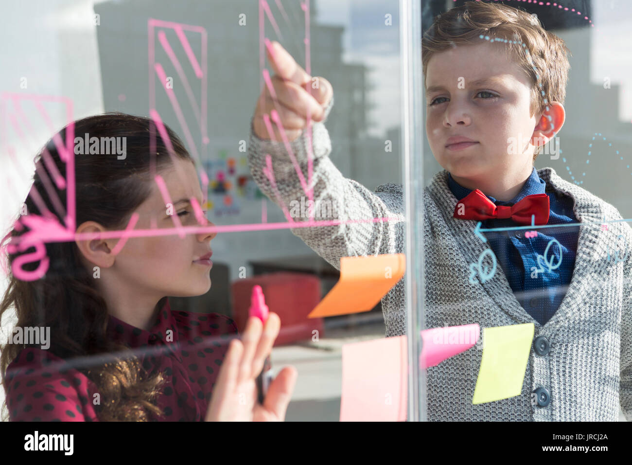 Business people analyzing graph on window seen through glass Stock Photo