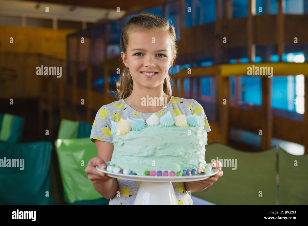 Portrait of smiling girl holding cake at home Stock Photo - Alamy