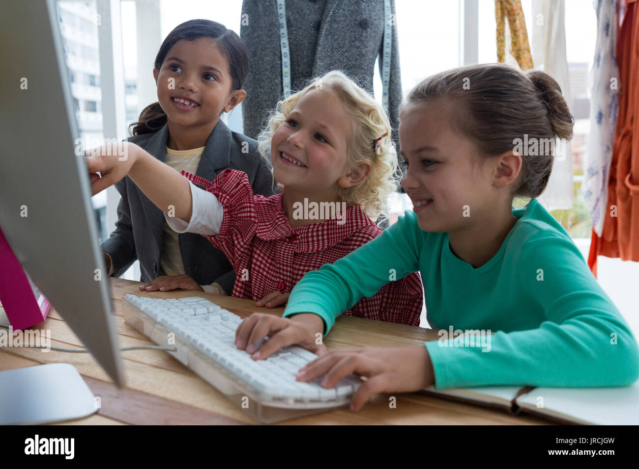 Female designers planning over computer in creative office Stock Photo