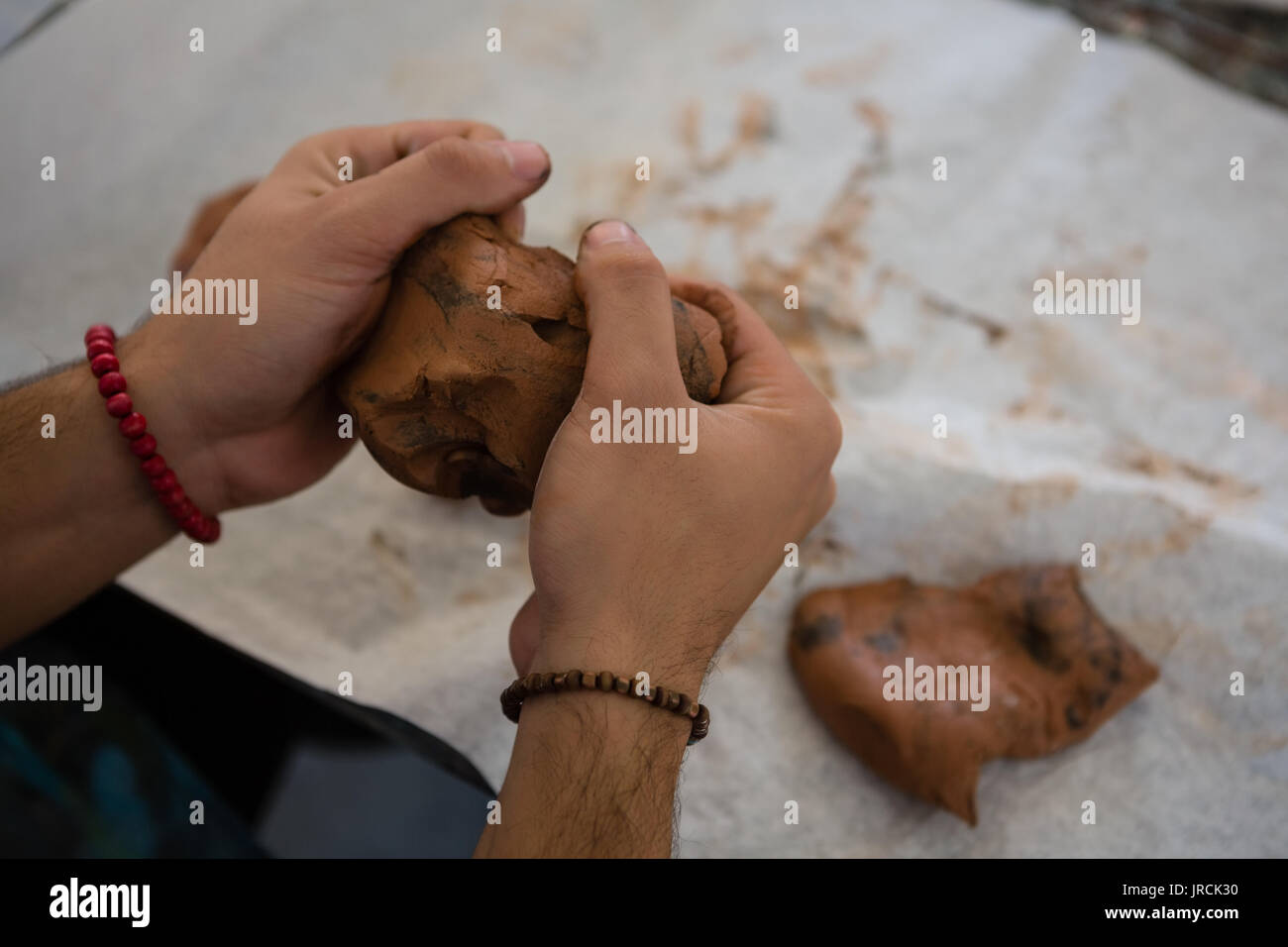 Cropped image of craftsperson making clay sculpture in art class Stock