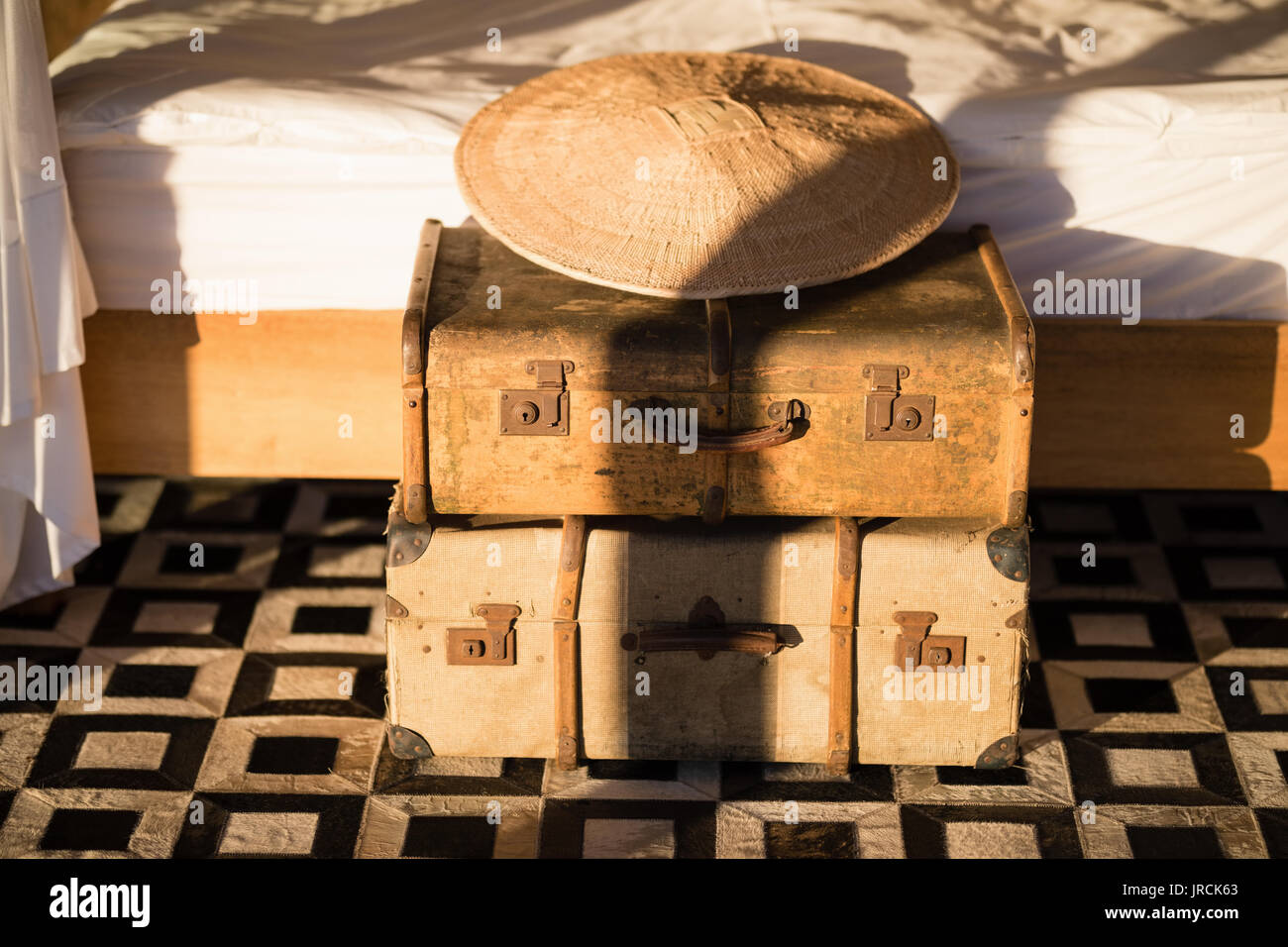 Classic vintage iron box and bamboo hat in cottage Stock Photo