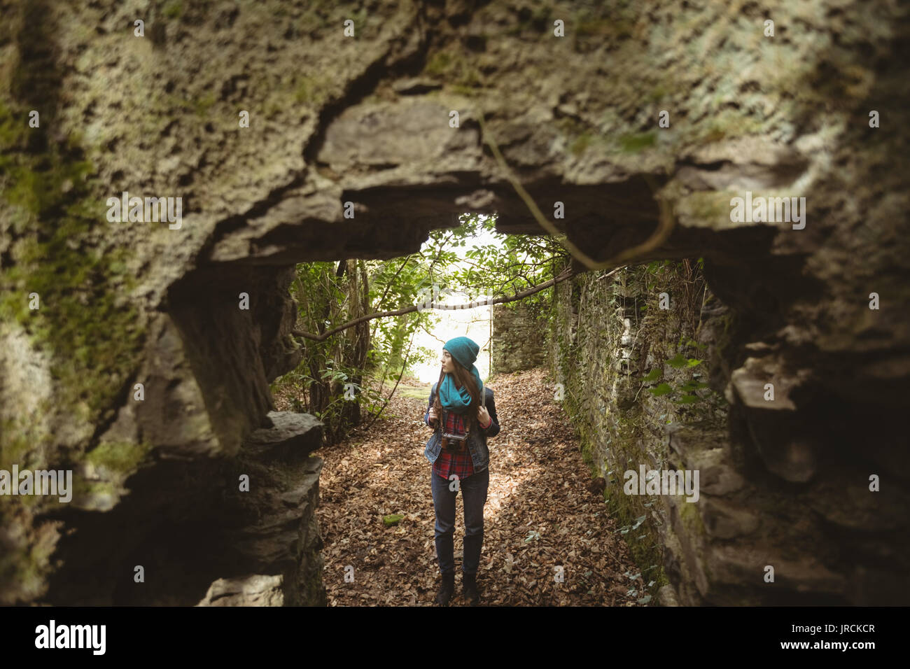 Thoughtful woman standing in forest Stock Photo
