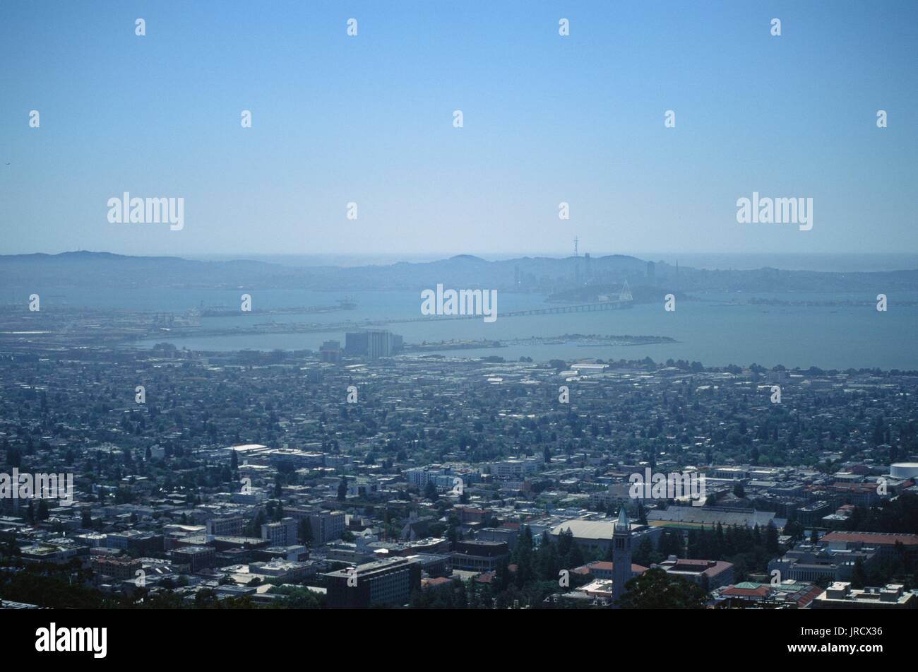 Aerial view of the University of California Berkeley (UC Berkeley), Emeryville, the San Francisco Bay and the Bay Bridge on a hazy day, from the Berkeley Hills, Berkeley, California, June 19, 2017. Stock Photo