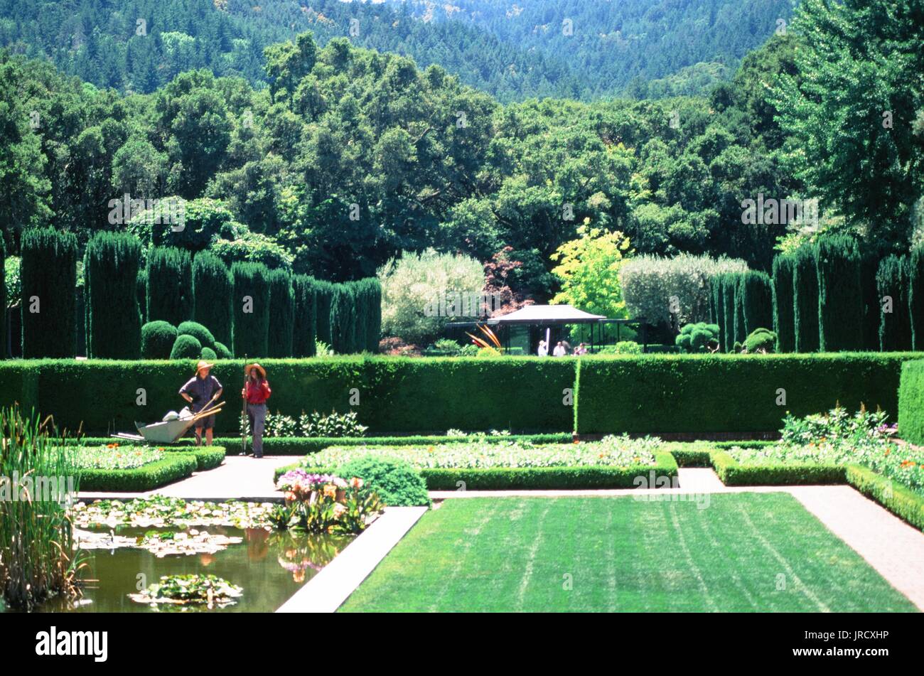 Two gardeners with a wheelbarrow tend to the sunken garden at Filoli Gardens, a restored Victorian style country estate and formal garden in Woodside, California, June 23, 2017. Stock Photo