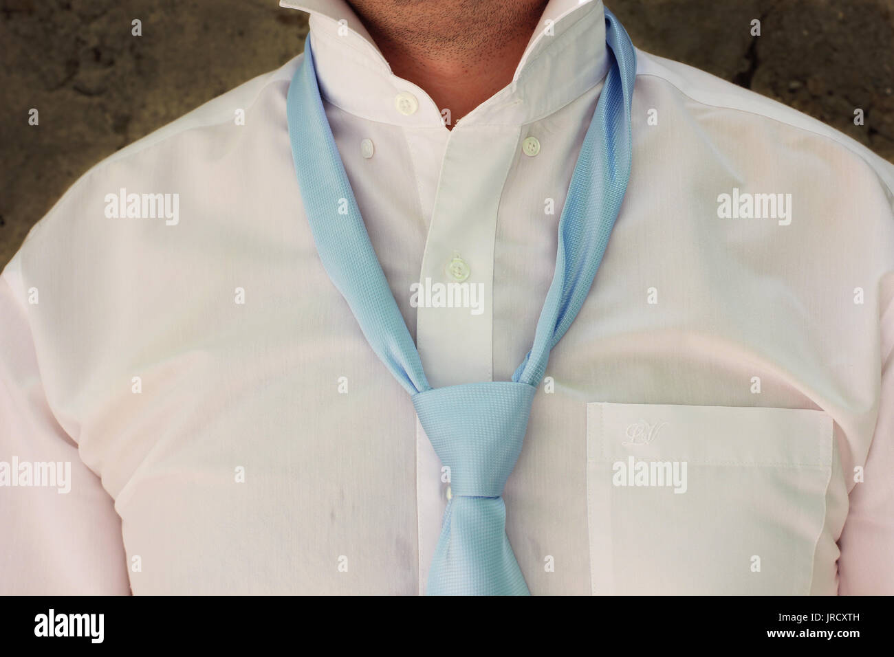View of Man in suit tying his necktie Stock Photo - Alamy