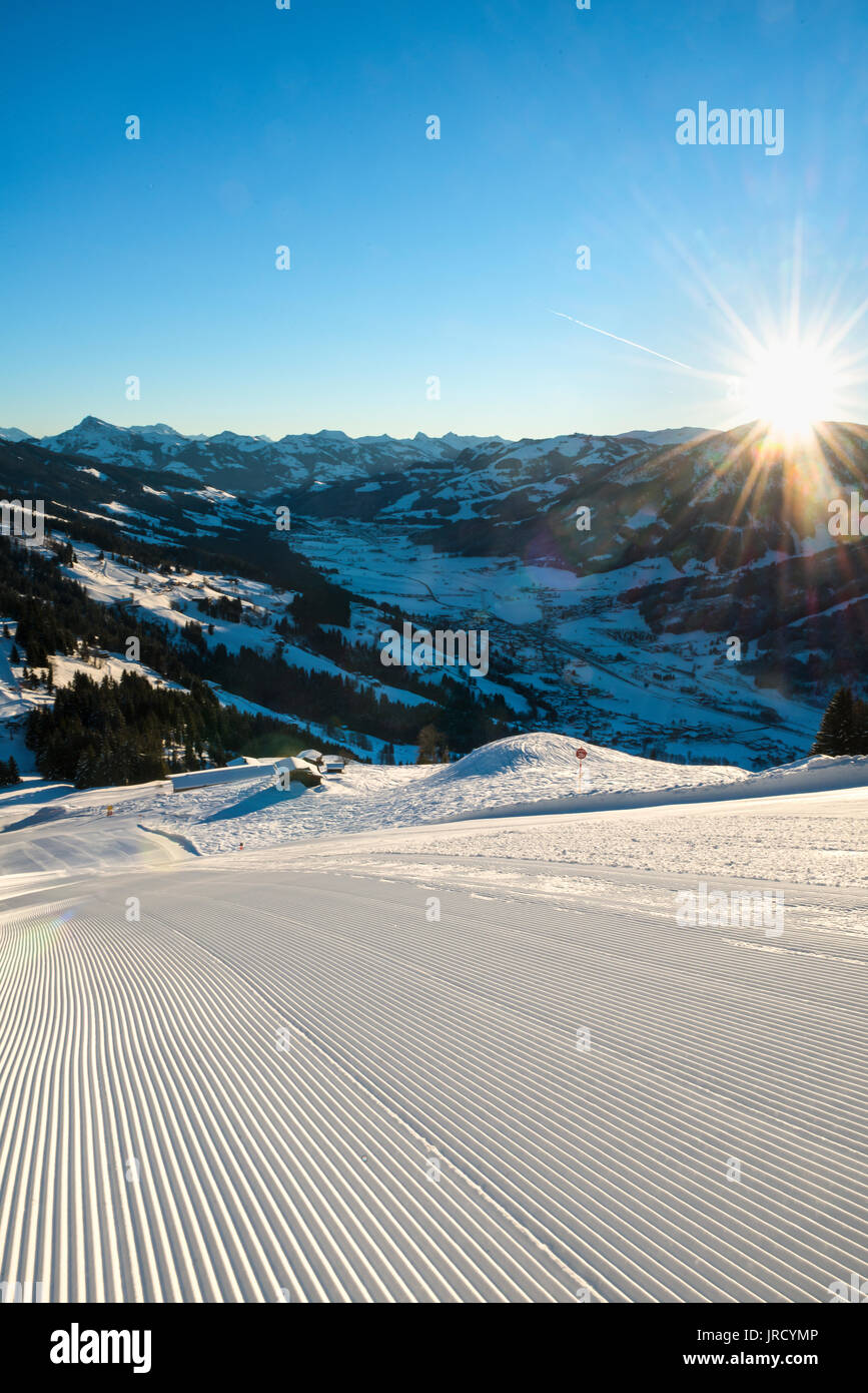 Freshly prepared ski slope with sunshine, morning sun, view to the Brixental, Skiwelt Wilder Kaiser-Brixental, Hochbrixen Stock Photo