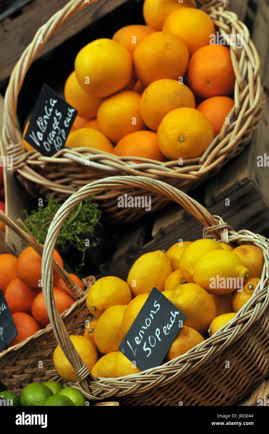 oranges and lemons fruit for sale in baskets at a market fruit and